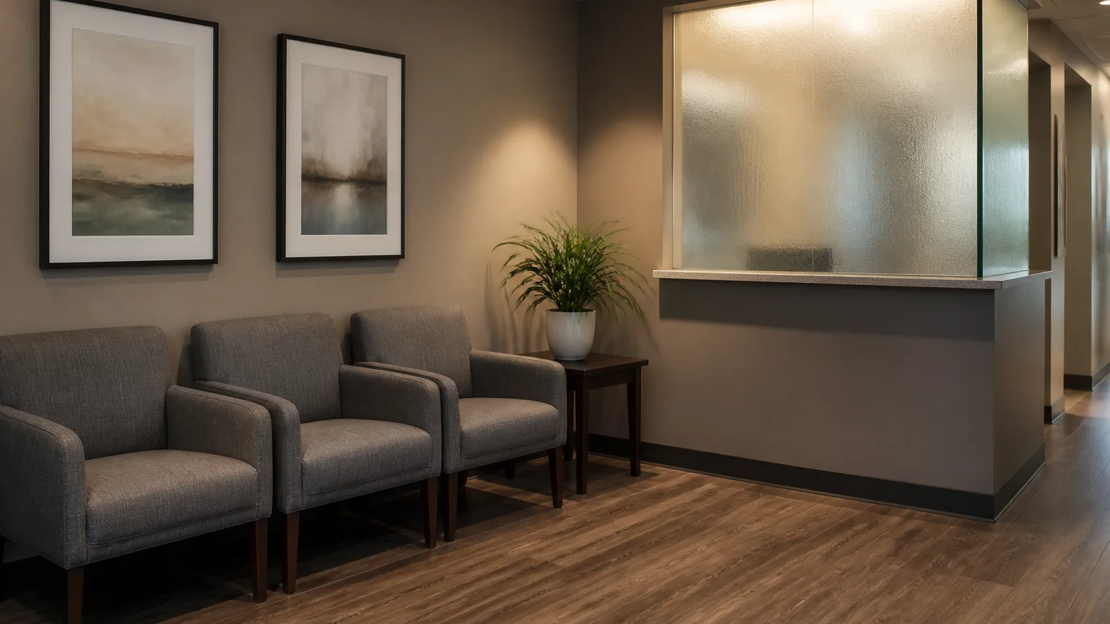 A professional service waiting room with neat chairs, a potted plant, and a frosted glass reception window, warm interior light.